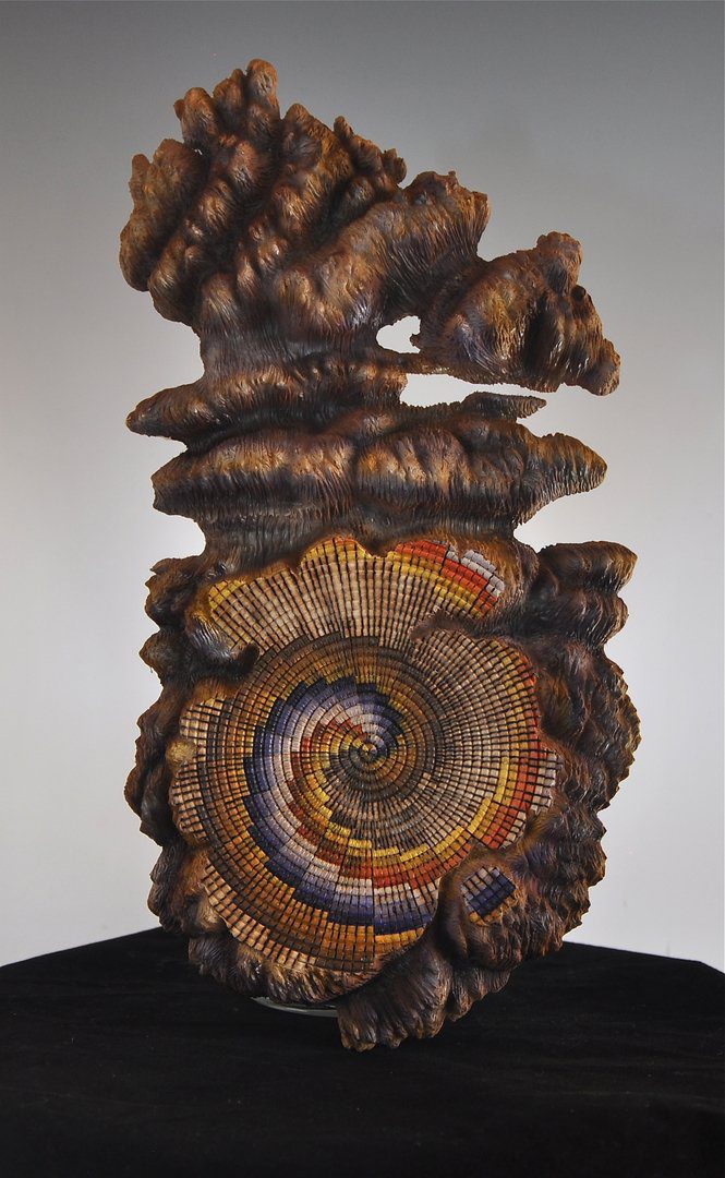 A sculpture of a spiral made out of wood.