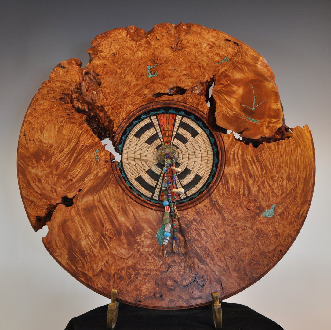 A wooden clock with a broken face on top of it.